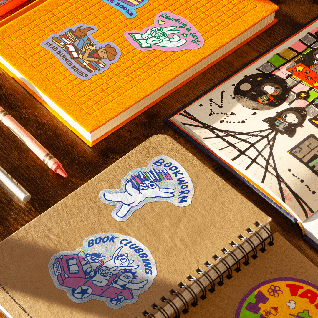 Notebooks with stickers on a desk with stationery items
